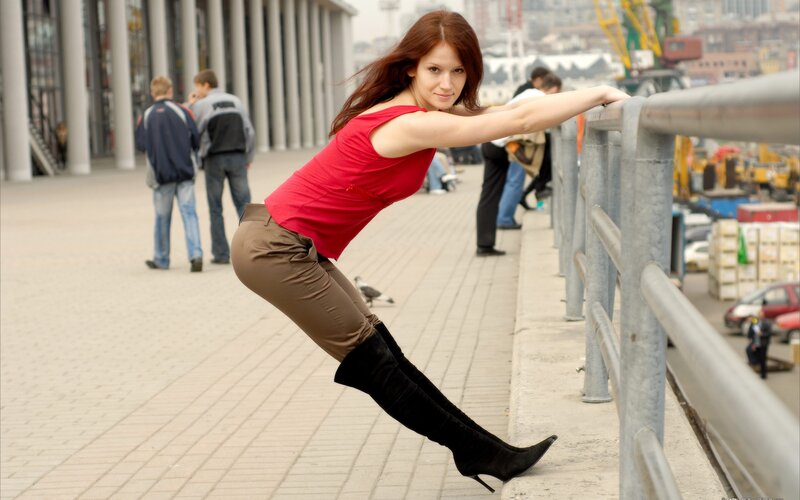 Woman in red top posing on railing