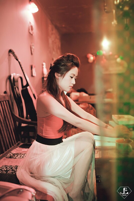 woman in red top sitting at table