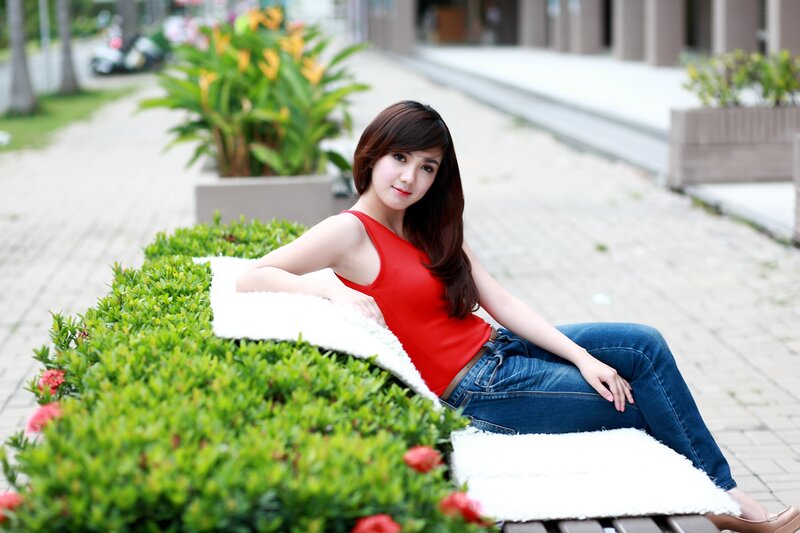woman in red top sitting on bench
