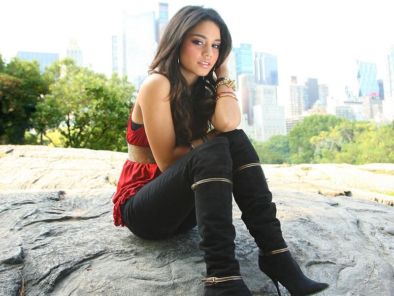 woman in red top sitting on rock