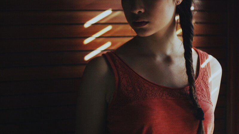 woman in red top with braid