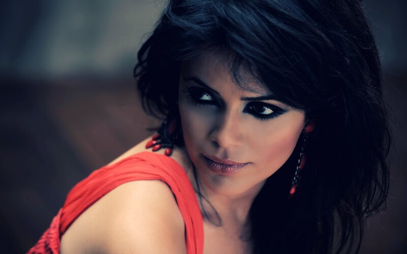woman in red top with dark hair