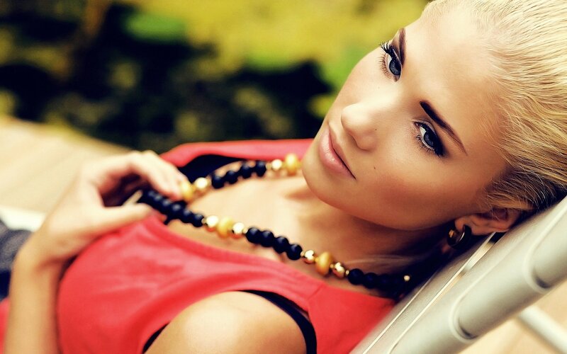 woman in red top with necklace