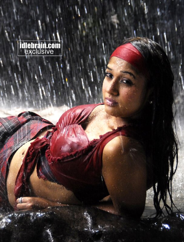 woman in red under waterfall