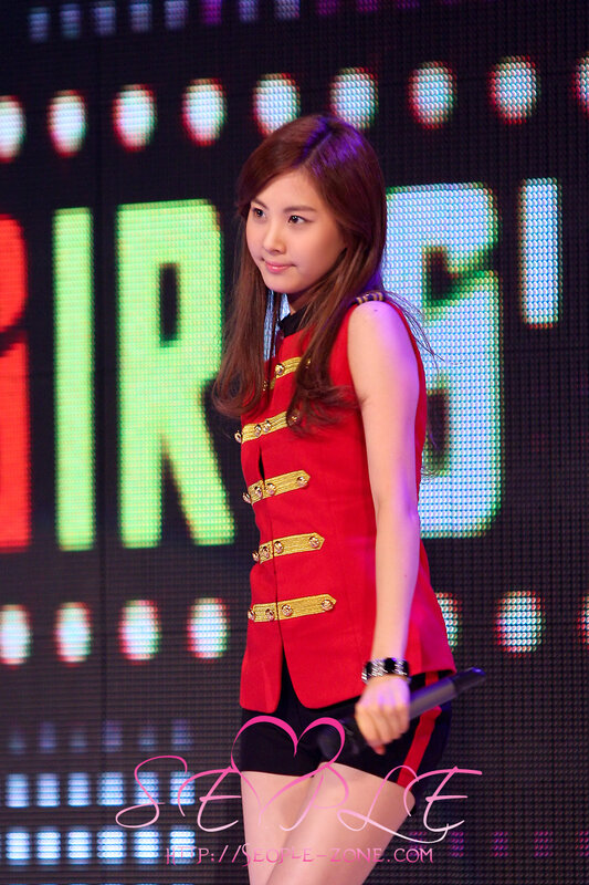 woman in red vest on stage