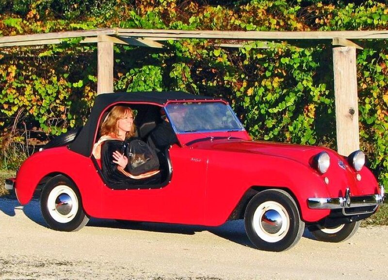 Woman in red vintage car