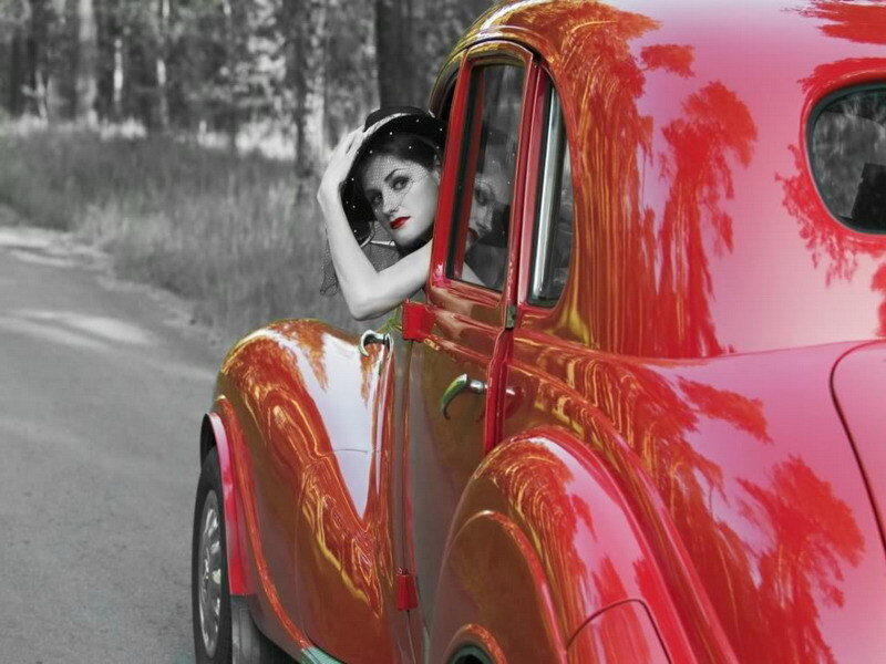 woman in red vintage car