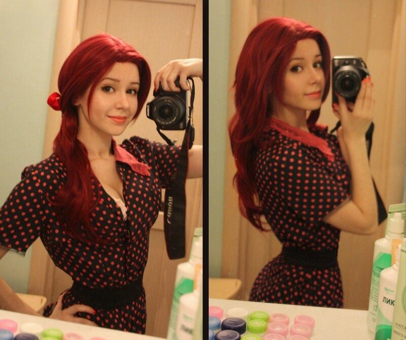 woman in red wig taking mirror selfie