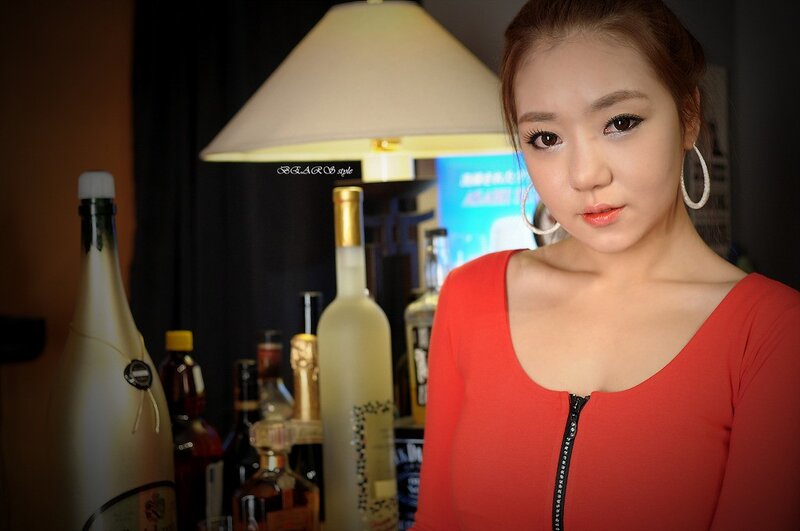 woman in red with alcohol bottles