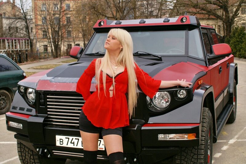 Woman in red with armored vehicle