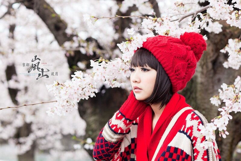Woman in red with cherry blossoms