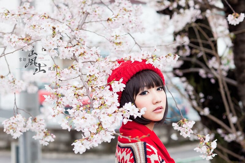Woman in red with cherry blossoms