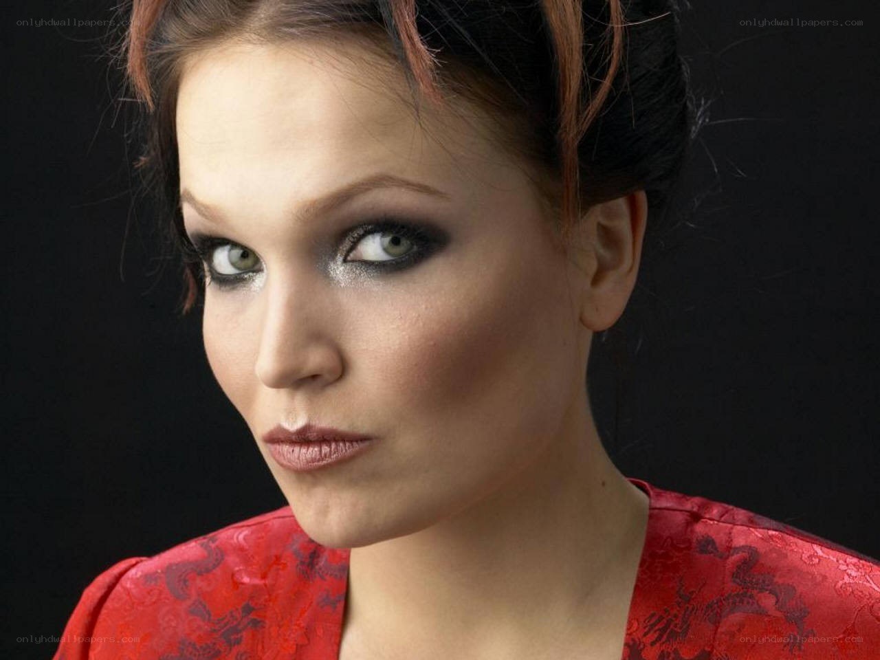woman in red with dramatic makeup