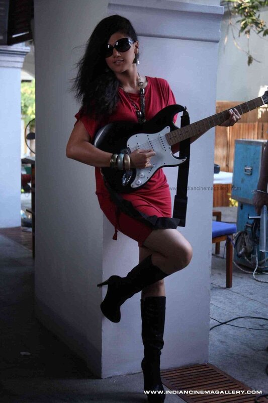 Woman in red with electric guitar