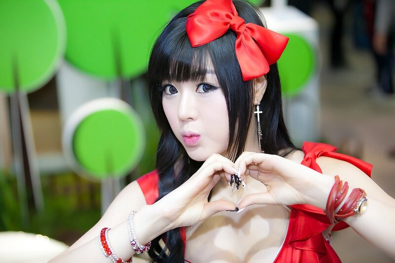 Woman in red with heart gesture