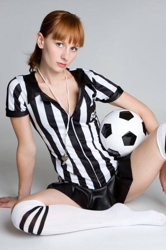 woman in referee uniform with soccer ball