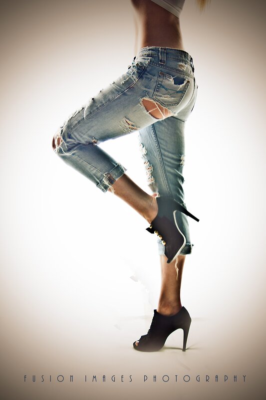 woman in ripped jeans and heels