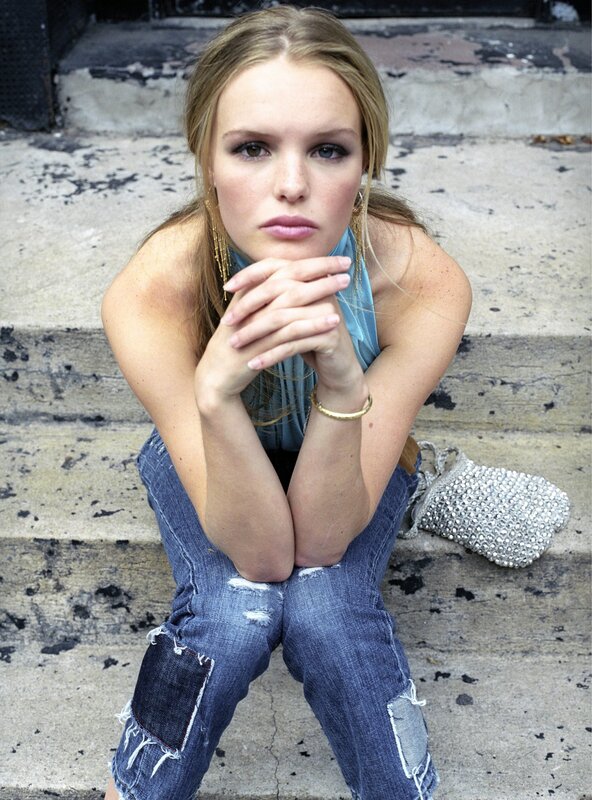 woman in ripped jeans on steps
