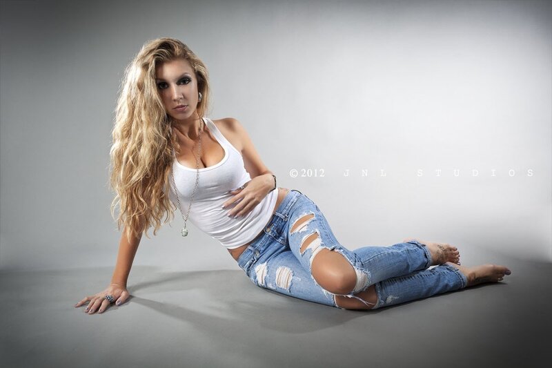 woman in ripped jeans posing