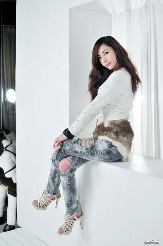 woman in ripped jeans sitting