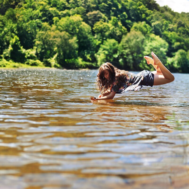 woman in river with phone