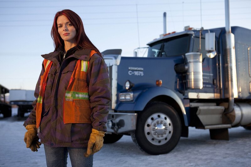 woman in safety gear near truck
