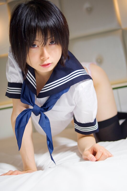 woman in sailor uniform on bed