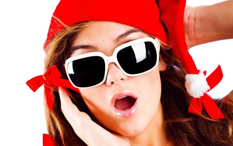 woman in santa hat and sunglasses