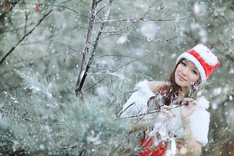 Woman in Santa hat during snowfall