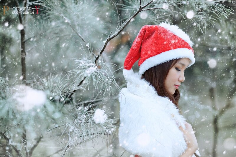 Woman in Santa hat during snowfall