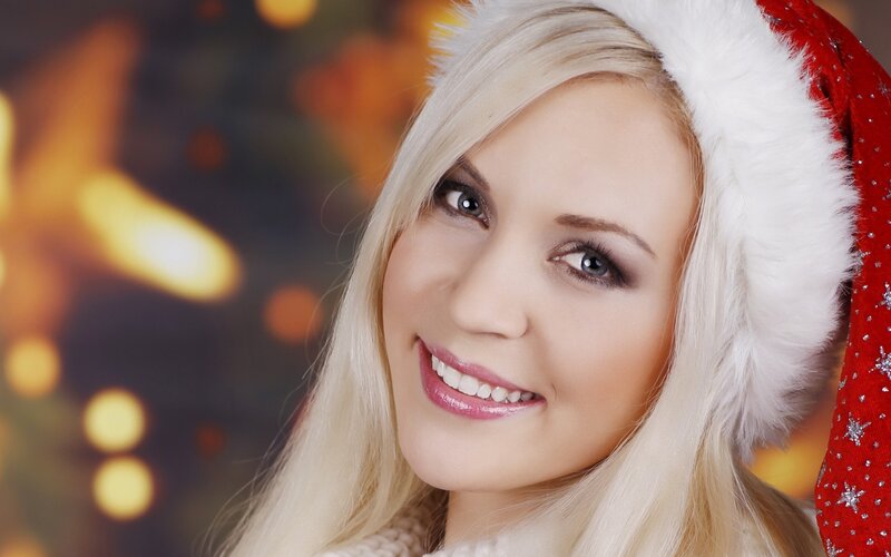 woman in santa hat smiling