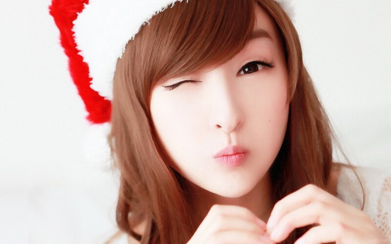 Woman in Santa Hat — White, Playful, Photograph