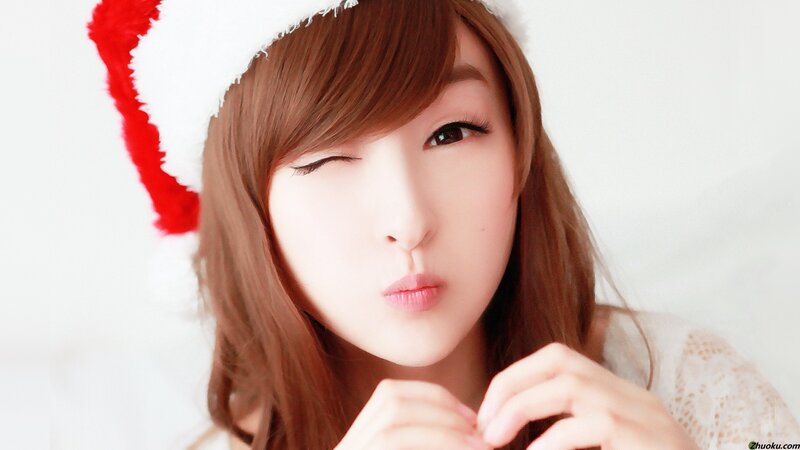 woman in santa hat winking