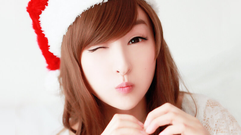 woman in santa hat winking