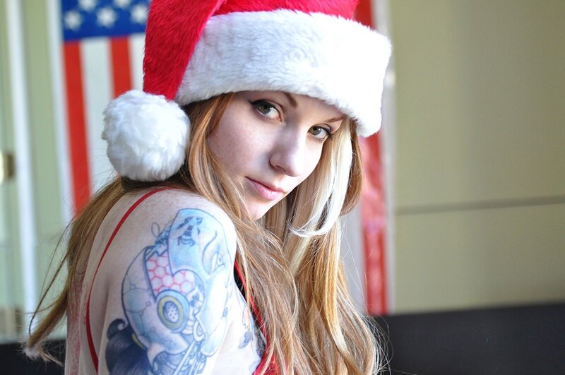 woman in santa hat with tattoo