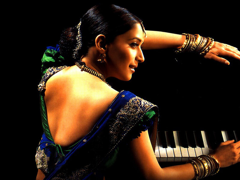 woman in sari playing piano