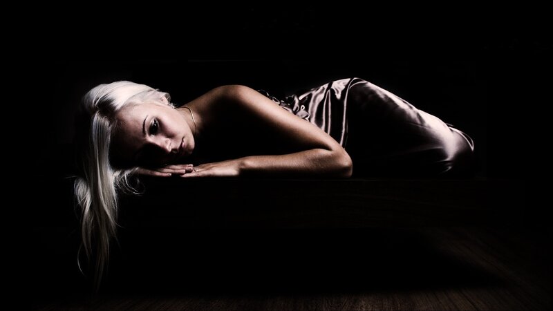 woman in satin dress lying down