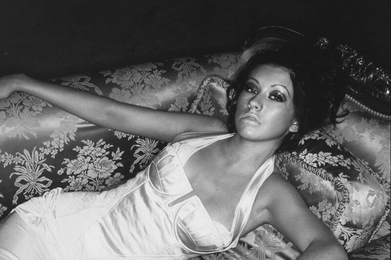woman in satin dress on floral couch