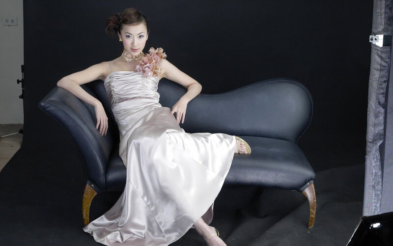 woman in satin gown on sofa