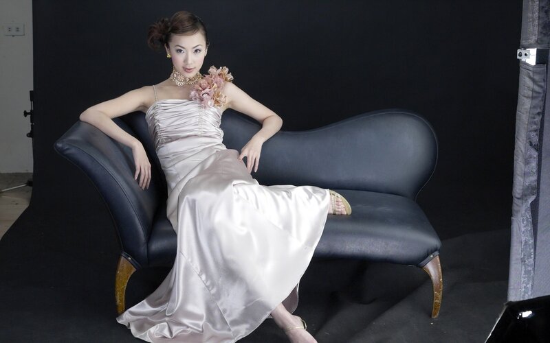 woman in satin gown on sofa
