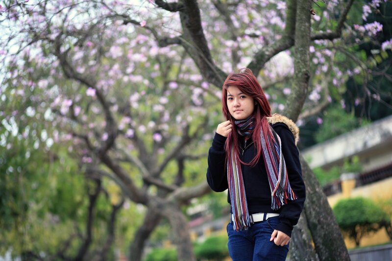 Woman in scarf by blooming tree
