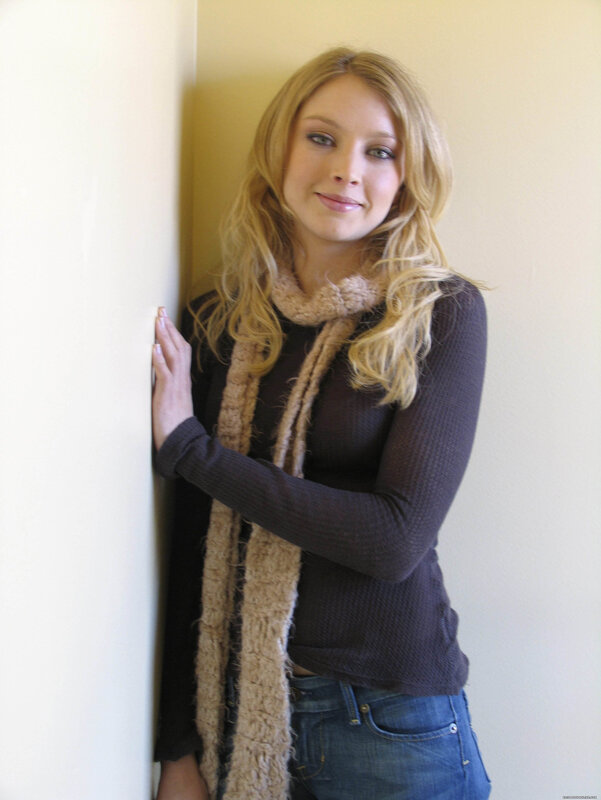 woman in scarf leaning on wall