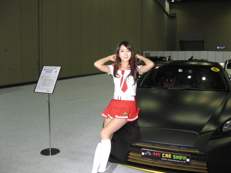 Woman in school uniform at car show