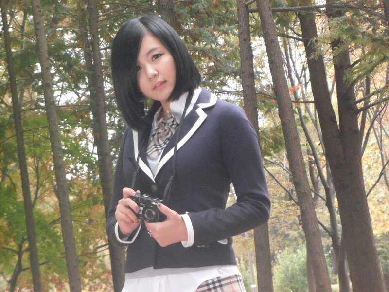 woman in school uniform holding camera