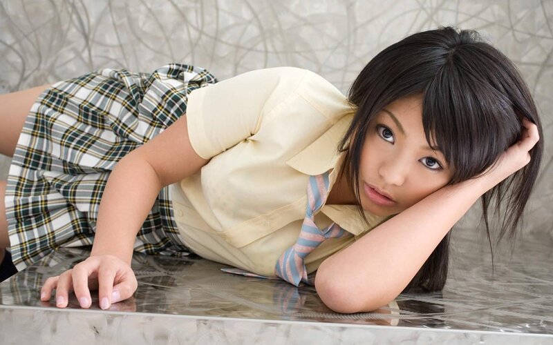 woman in school uniform lying down
