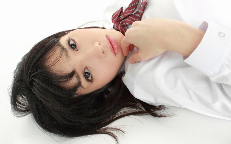 woman in school uniform lying down