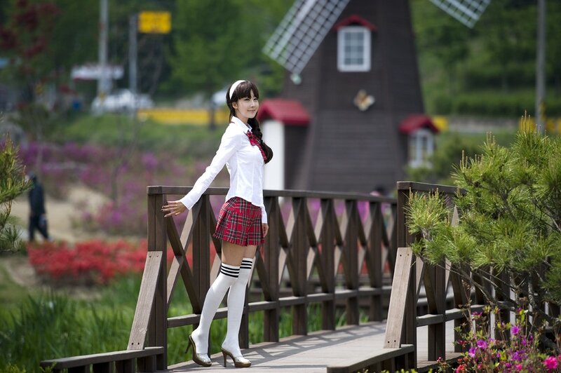 Woman in school uniform on a bridge