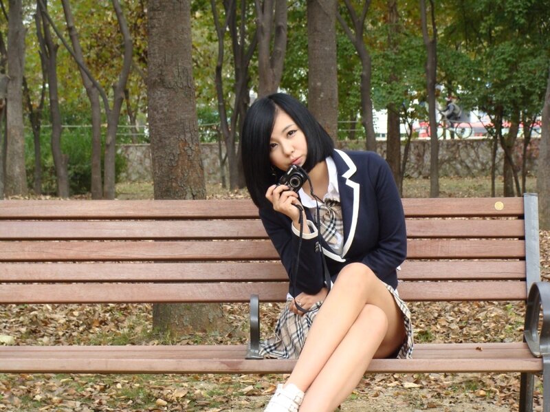 Woman in school uniform on bench