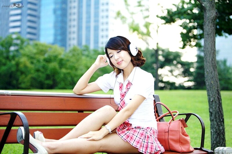 Woman in school uniform on bench