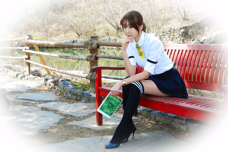 woman in school uniform on bench